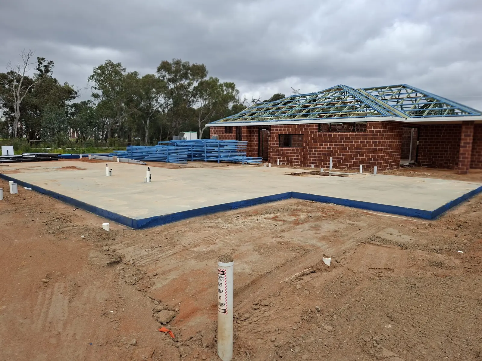 Brick walls and roof framing under construction